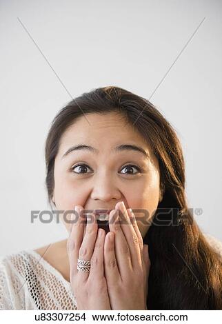 Picture - Studio shot of beautiful young woman laughing. Fotosearch