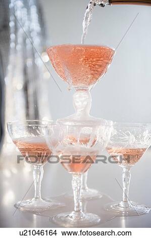 Picture - Studio Shot of champagne filling pyramid. Fotosearch