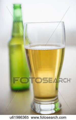 Studio shot of glass of beer and beer bottle View Large Photo Image Stock Photography - Studio shot of glass of beer and beer bottle. Fotosearch