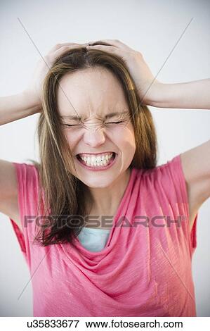 Stock Photo - Studio shot of young woman in distress. Fotosearch