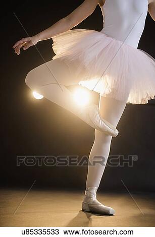 Teenage (16-17) ballerina on stage standing on one leg View Large Photo Image Stock Image - Teenage (16-17) ballerina on stage standing on one leg. Fotosearch
