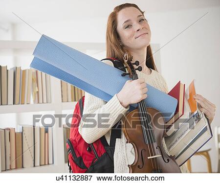 Teenage girl (14-15) carrying school equipment View Large Photo Image Stock Photo - Teenage girl (14-15) carrying school equipment. Fotosearch