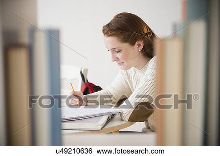 Teenage girl (14-15) studying in library View Large Photo Image Stock Photograph - Teenage girl (14-15) studying in library. Fotosearch