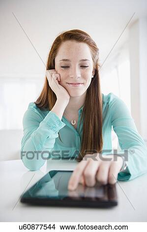 Teenage girl (14-15) using digital tablet View Large Photo Image Picture - Teenage girl (14-15) using digital tablet. Fotosearch