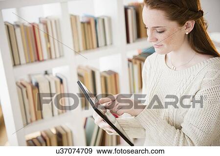 Teenage girl (14-15) using digital tablet View Large Photo Image Stock Photo - Teenage girl (14-15) using digital tablet. Fotosearch
