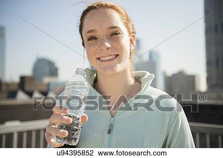 Teenage girl (14-15) with bottle of water View Large Photo Image Stock Image - Teenage girl (14-15) with bottle of water. Fotosearch