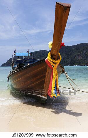 Stock Photo - Traditional boat moored on beach. Fotosearch