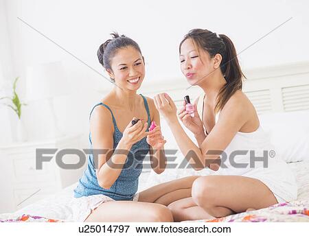 Stock Photo - Two women doing manicure. Fotosearch