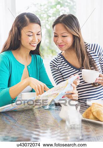 Picture - Two women looking at map. Fotosearch