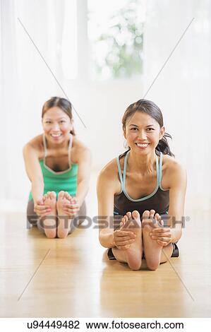 Two women on yoga class View Large Photo Image Stock Image - Two women on yoga class. Fotosearch