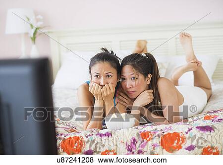 Two women watching tv View Large Photo Image Stock Photo - Two women watching tv. Fotosearch
