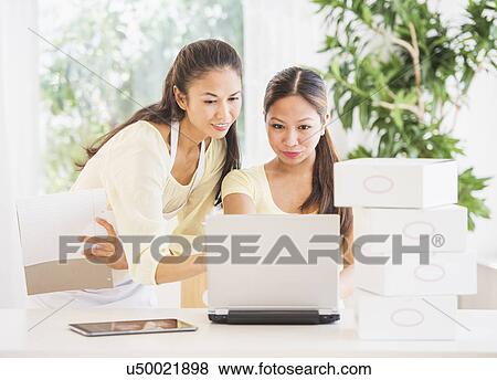 Two women working View Large Photo Image Stock Photo - Two women working. Fotosearch