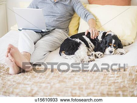 Stock Image - View of mature man using laptop at home. Fotosearch