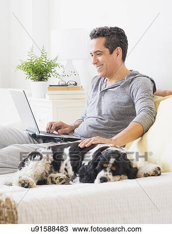 View of mature man using laptop at home View Large Photo Image Stock Image - View of mature man using laptop at home. Fotosearch