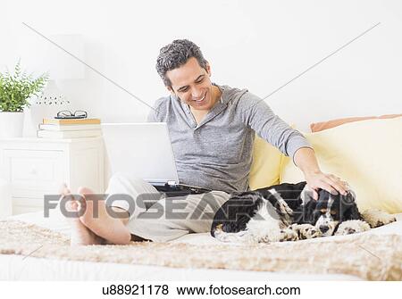 View of mature man using laptop at home View Large Photo Image Stock Photo - View of mature man using laptop at home. Fotosearch
