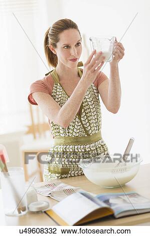 Woman cooking in kitchen View Large Photo Image Stock Image - Woman cooking in kitchen. Fotosearch