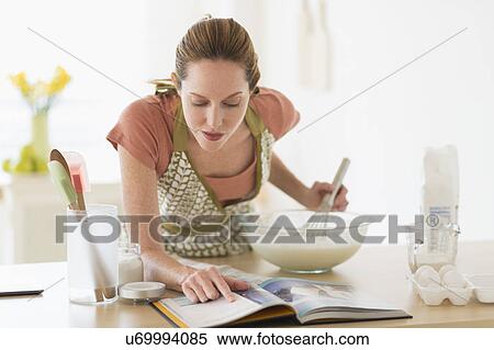 Woman cooking in kitchen View Large Photo Image Stock Photography - Woman cooking in kitchen. Fotosearch