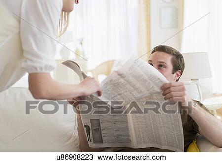 Woman disturbing her partner in reading newspaper View Large Photo Image Stock Image - Woman disturbing her partner in reading newspaper. Fotosearch
