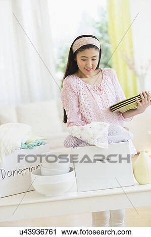Woman donating household items View Large Photo Image Stock Image - Woman donating household items. Fotosearch