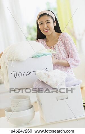 Woman donating household items View Large Photo Image Stock Image - Woman donating household items. Fotosearch