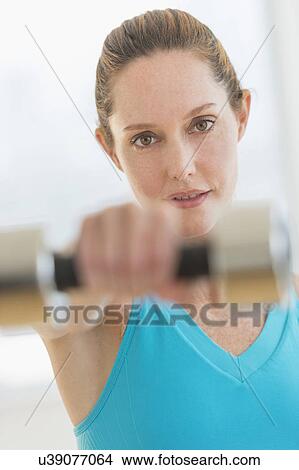 Woman exercising with weights View Large Photo Image Picture - Woman exercising with weights. Fotosearch