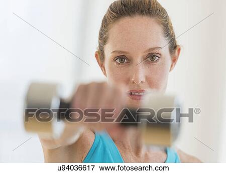 Stock Photo - Woman exercising with weights. Fotosearch