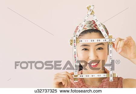 Stock Photography - Woman holding tape measure . Fotosearch