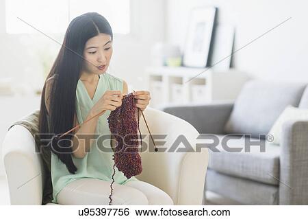 Stock Photograph - Woman knitting at home. Fotosearch