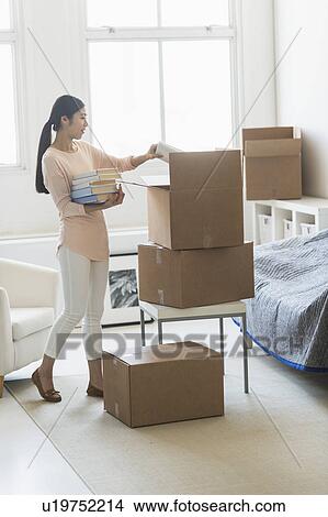 Woman moving home View Large Photo Image Picture - Woman moving home. Fotosearch
