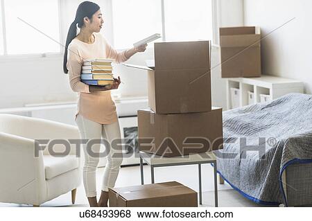 Woman moving home View Large Photo Image Stock Photo - Woman moving home. Fotosearch