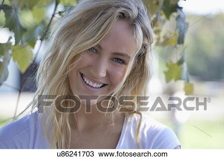 Stock Image - Woman posing outdoors. Fotosearch
