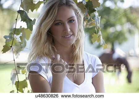 Stock Photograph - Woman posing outdoors. Fotosearch
