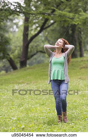 Woman relaxing in park View Large Photo Image Picture - Woman relaxing in park. Fotosearch