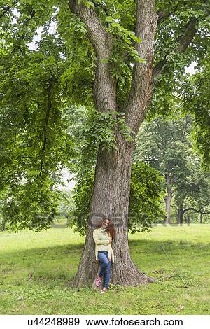 Woman relaxing in park View Large Photo Image Stock Photo - Woman relaxing in park. Fotosearch