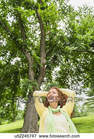 Woman relaxing in park View Large Photo Image Stock Photo - Woman relaxing in park. Fotosearch