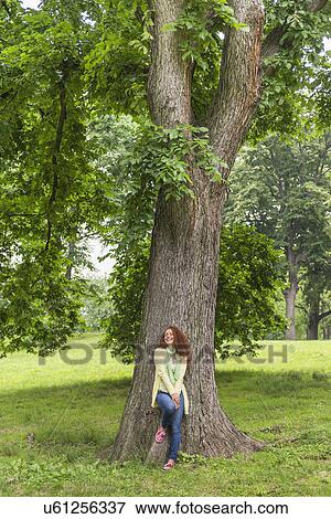 Woman relaxing in park View Large Photo Image Stock Photo - Woman relaxing in park. Fotosearch