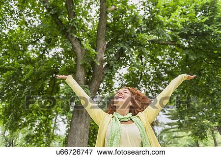 Woman relaxing in park View Large Photo Image Stock Photo - Woman relaxing in park. Fotosearch