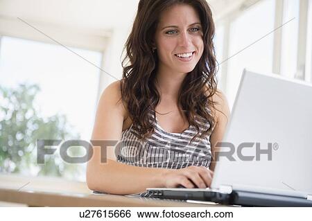 Stock Photograph - Woman using laptop. Fotosearch