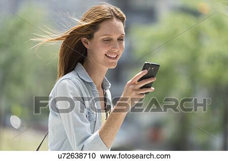 Woman using phone View Large Photo Image Stock Image - Woman using phone. Fotosearch