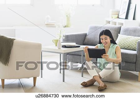 Woman using tablet pc at home View Large Photo Image Stock Image - Woman using tablet pc at home. Fotosearch