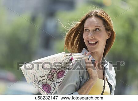 Stock Photo - Woman with shopping bags. Fotosearch