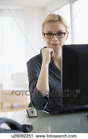 Young businesswoman in office View Large Photo Image Stock Image - Young businesswoman in office. Fotosearch
