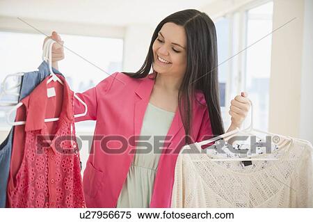 Young woman in clothes store View Large Photo Image Stock Photography - Young woman in clothes store. Fotosearch