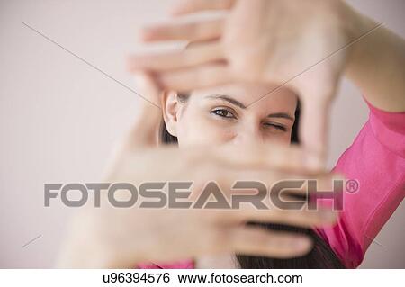 Young woman measuring length with hands View Large Photo Image Stock Photograph - Young woman measuring length with hands. Fotosearch