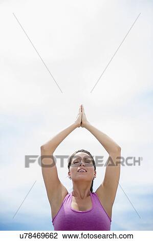 Stock Image - Young woman meditating. Fotosearch