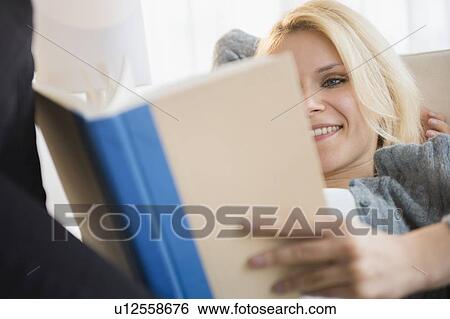 Stock Photograph - Young woman reading book. Fotosearch