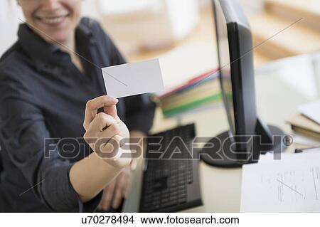 Picture - Young woman showing blank business card. Fotosearch