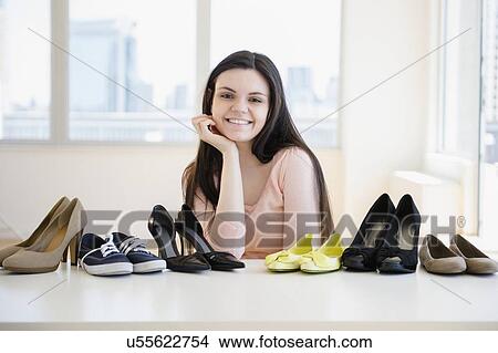 Young woman surrounded by shoes View Large Photo Image Picture - Young woman surrounded by shoes. Fotosearch