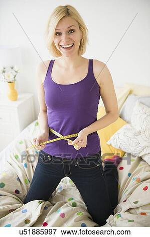 Young woman with measuring tape View Large Photo Image Stock Photo - Young woman with measuring tape. Fotosearch