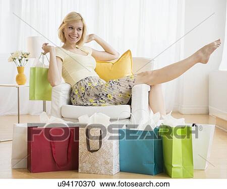 Stock Image - Young woman with shopping bags. Fotosearch